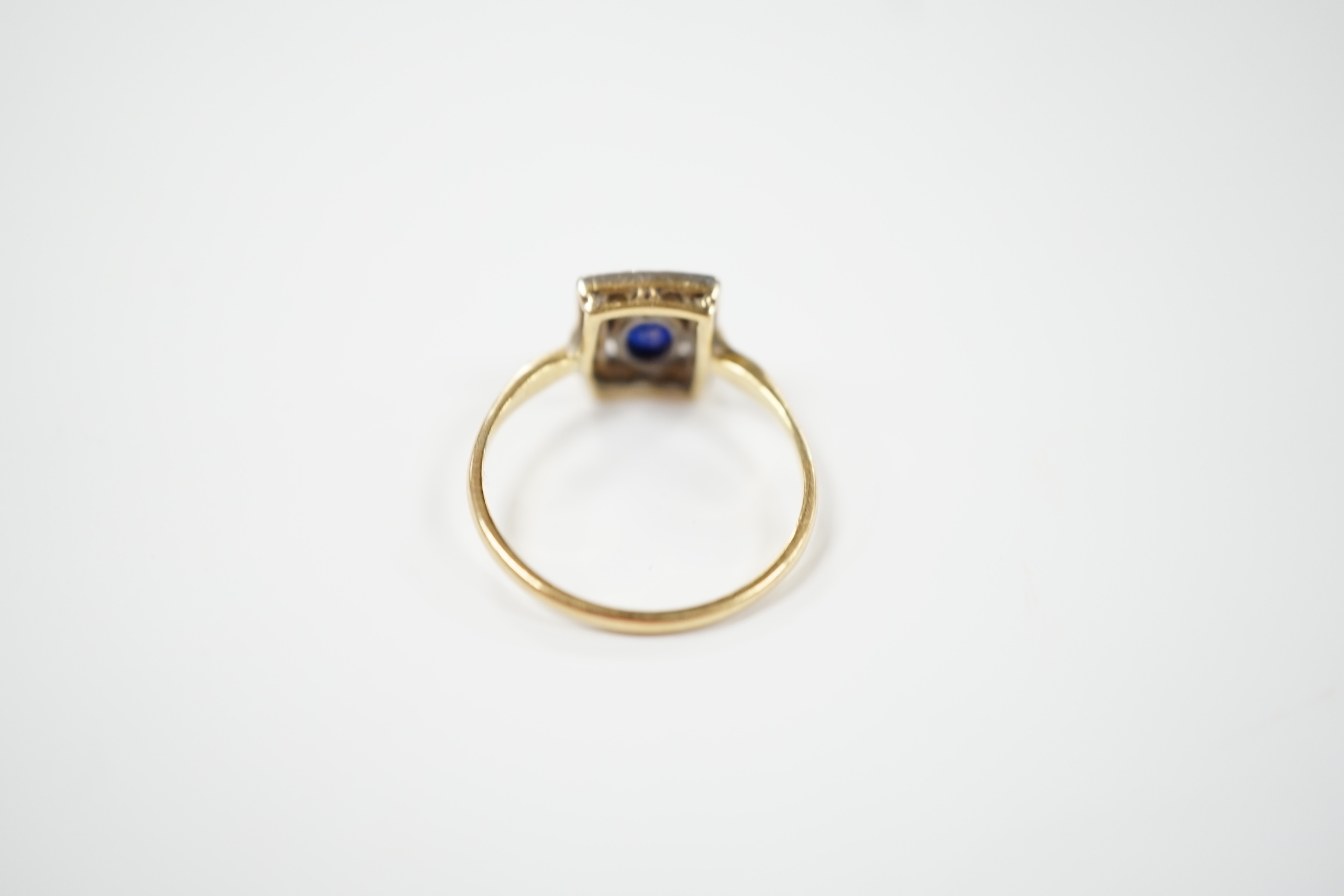 A yellow metal, sapphire and diamond cluster set tablet ring, size P, gross weight 2.3 grams.